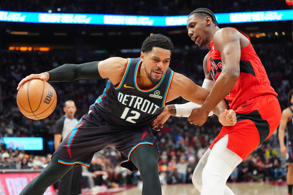 Detroit Pistons forward Tobias Harris (12) controls the ball as Toronto Raptors forward RJ Barrett, right, defends during second-half NBA basketball game action in Toronto, Sunday, March 15, 2026. (Frank Gunn/The Canadian Press via AP)