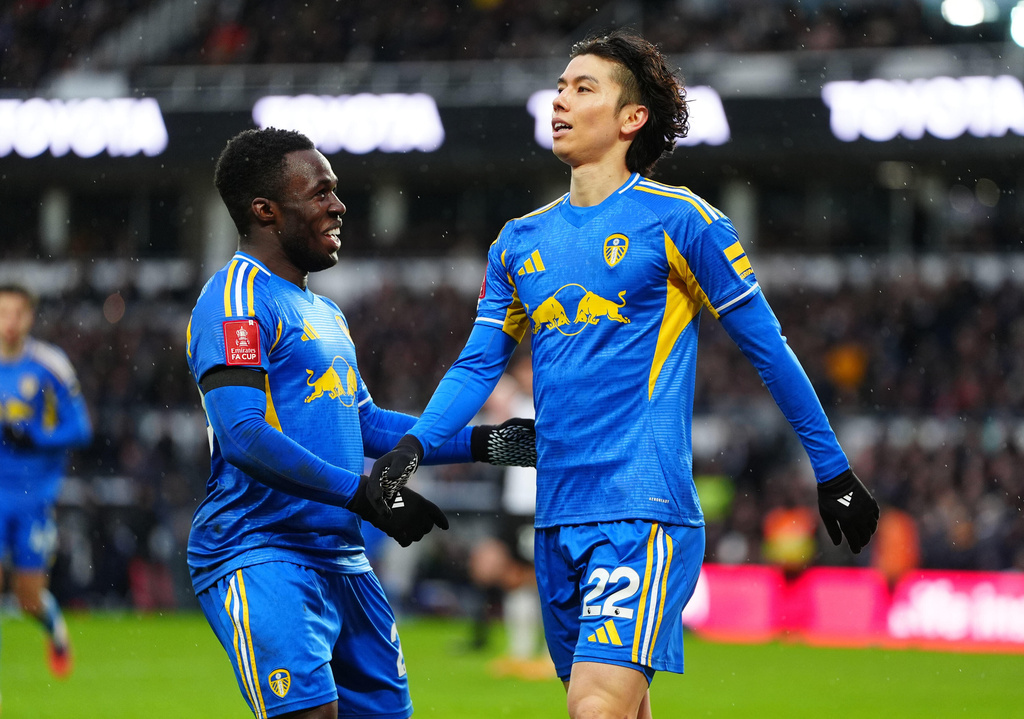 Leeds United's Ao Tanaka, right, celebrates with Wilfried Gnonto after scoring their side's second goal of the game during the Emirates FA Cup third round match between Derby County and Leeds United, in Derby, England, Sunday Jan. 11, 2026. (David Davies/PA via AP)