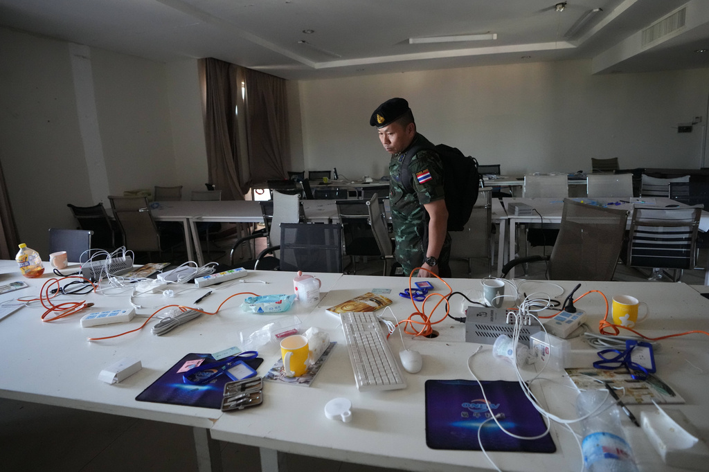 FILE -A Thai solider inspects a work station inside a scam center in O'Smach, Cambodia, Feb. 2, 2026, (AP Photo/Sakchai Lalit), File)