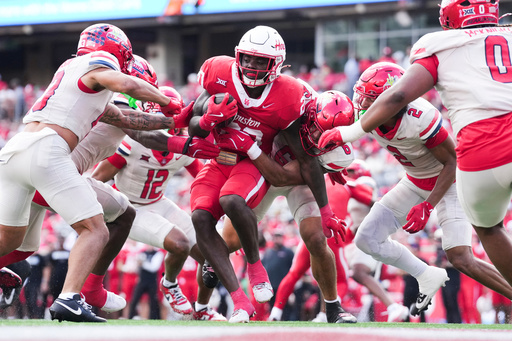 Houston running back J'Marion Burnette (20) is tackled by Arizona linebacker Taye Brown (6) during the first half of an NCAA college football game, Saturday, Oct. 18, 2025, in Houston. (Jason Fochtman/Houston Chronicle via AP) Houston running back J'Marion Burnette (20) is tackled by Arizona linebacker Taye Brown (6) during the first half of an NCAA college football game, Saturday, Oct. 18, 2025, in Houston. (Jason Fochtman/Houston Chronicle via AP)