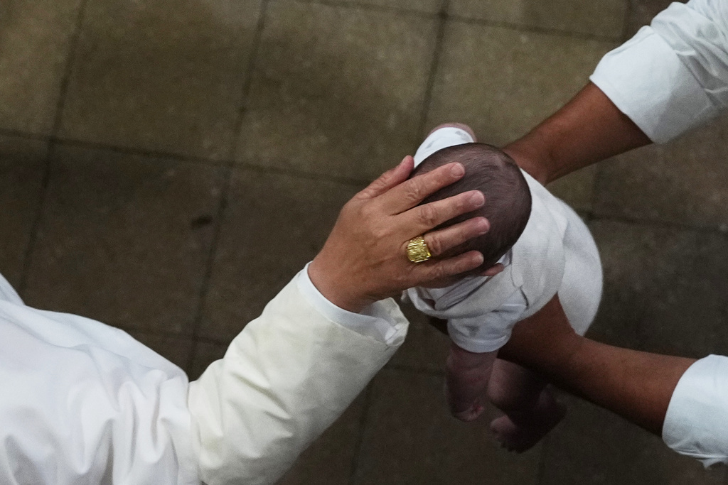 Pope Leo XIV blesses a child as he meets with faithful and members of the diocesan charity and welfare organizations in the Church of Sant Agusti in Barcelona, Spain, Wednesday, June 10, 2026 (AP Photo/Alessandra Tarantino)