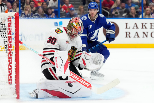 Chicago Blackhawks goaltender Spencer Knight (30) makes a save as Tampa Bay Lightning center Brayden Point (21) moves in for a rebound during the second period of an NHL hockey game Thursday, Oct. 23, 2025, in Tampa, Fla. (AP Photo/Chris O'Meara) Chicago Blackhawks goaltender Spencer Knight (30) makes a save as Tampa Bay Lightning center Brayden Point (21) moves in for a rebound during the second period of an NHL hockey game Thursday, Oct. 23, 2025, in Tampa, Fla. (AP Photo/Chris O'Meara)