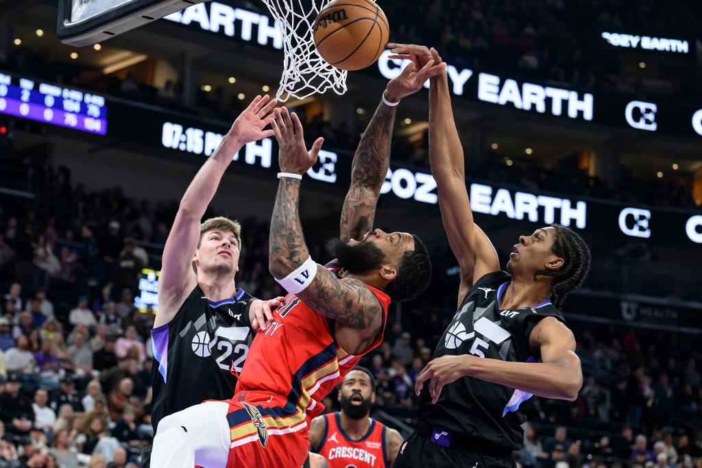 New Orleans Pelicans guard Saddiq Bey, center, has the ball blocked by Utah Jazz forward Cody Williams, right, during the first half of an NBA basketball game, Thursday, Feb. 26, 2026, in Salt Lake City. (AP Photo/Tyler Tate)
