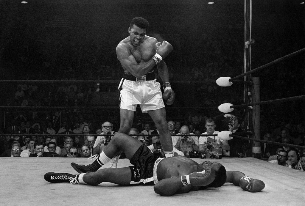 FILE - Heavyweight champion Muhammad Ali stands over fallen challenger Sonny Liston, shouting and gesturing shortly after dropping Liston with a short hard right to the jaw on May 25, 1965, in Lewiston, Maine. (AP Photo/John Rooney, file)