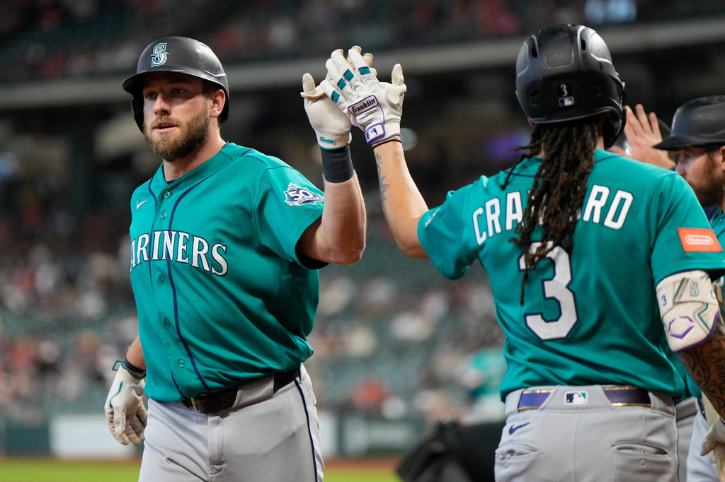 Seattle Mariners' Luke Raley, left, celebrates with J.P. Crawford after hitting a home run during the first inning of a baseball game against the Houston Astros in Houston, Thursday, May 14, 2026. (AP Photo/Ashley Landis)