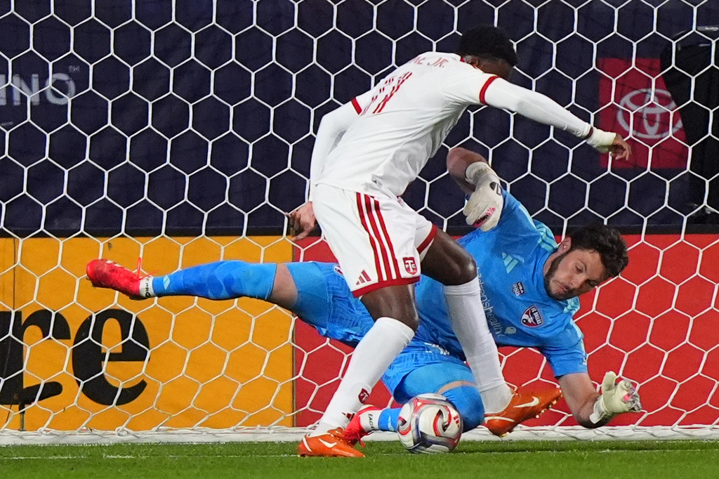 FC Dallas goalkeeper Michael Collodi, bottom, defends the goal against Toronto FC forward Derrick Etienne Jr., top, during the first half of an MLS soccer match in Frisco, Texas, Saturday, Feb. 21, 2026. (AP Photo/LM Otero)