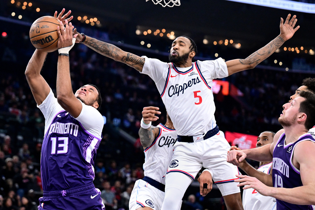 Sacramento Kings forward Keegan Murray (13) has his shot blocked by Los Angeles Clippers forward Derrick Jones Jr. (5) in the first half of an NBA basketball game Tuesday, Dec. 30, 2025, in Inglewood, Calif. (AP Photo/Wally Skalij)
