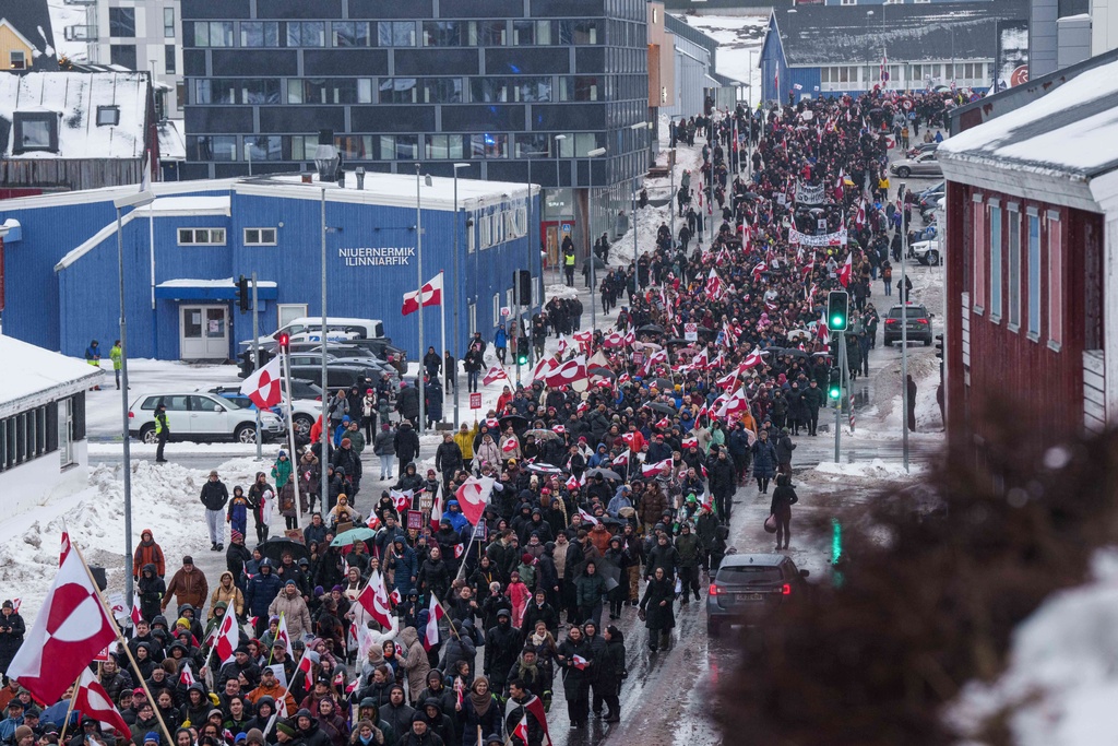 A crowd walks to the US consulate to protest against Trump's policy towards Greenland in Nuuk, Greenland, Saturday, Jan. 17, 2026. (AP Photo/Evgeniy Maloletka)