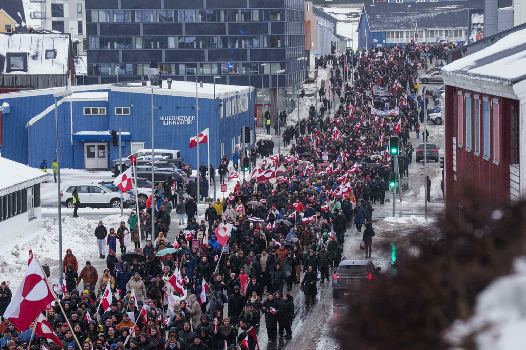 A crowd walks to the US consulate to protest against Trump's policy towards Greenland in Nuuk, Greenland, Saturday, Jan. 17, 2026. (AP Photo/Evgeniy Maloletka)