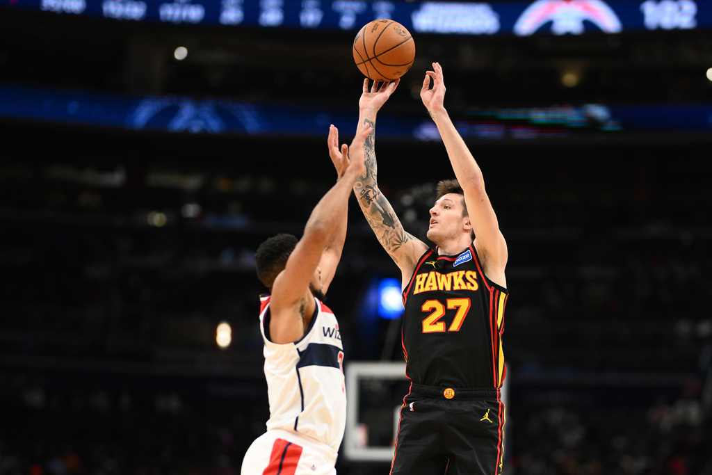 Atlanta Hawks guard Vit Krejci (27) shoots against Washington Wizards guard CJ McCollum, left, during the second half of an NBA basketball game, Saturday, Dec. 6, 2025, in Washington. (AP Photo/Nick Wass)