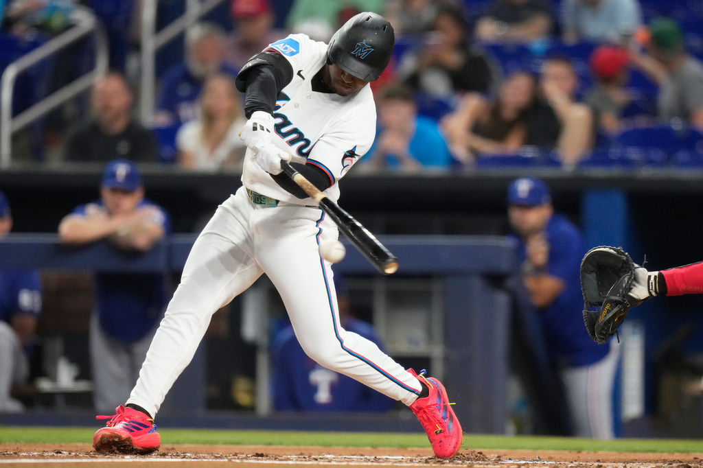 Miami Marlins' Xavier Edwards hits a single during the first inning of a baseball game against the Texas Rangers, Tuesday, June 23, 2026, in Miami. (AP Photo/Lynne Sladky)