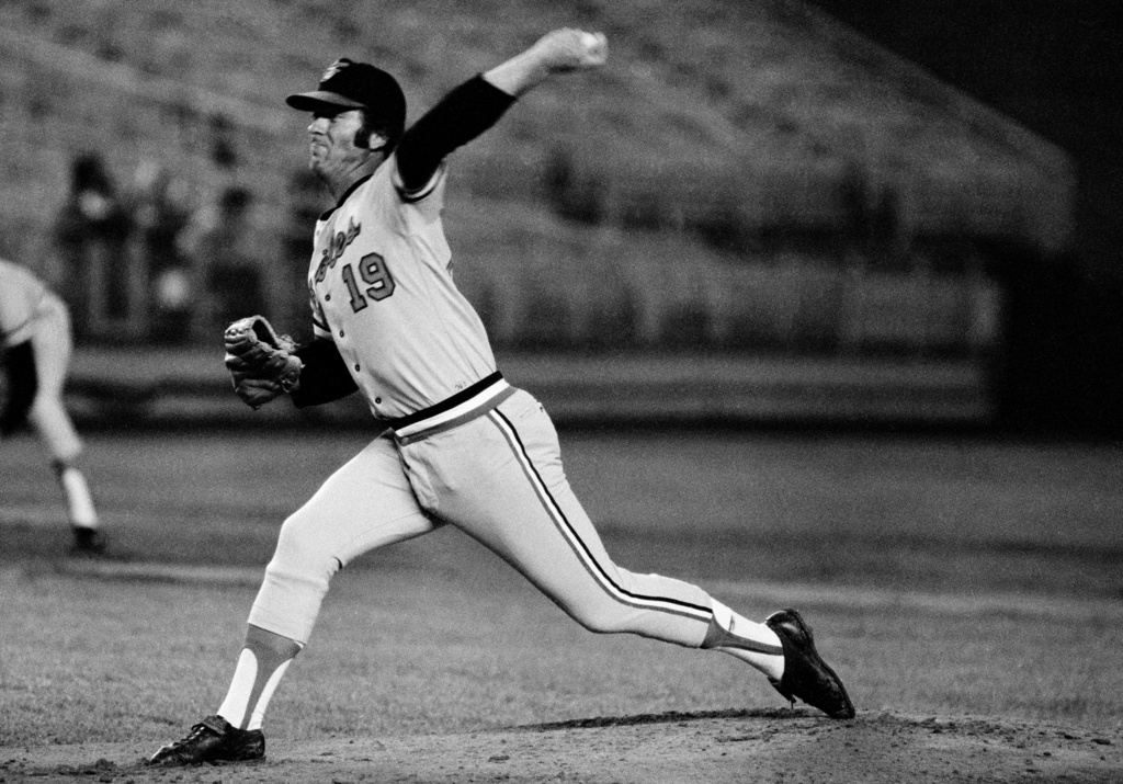 FILE - Baltimore Orioles Dave McNally delivers a pitch in the first inning of a baseball game against the New York Yankees at Shea Stadium in New York, May 24, 1974. (AP Photo/File)