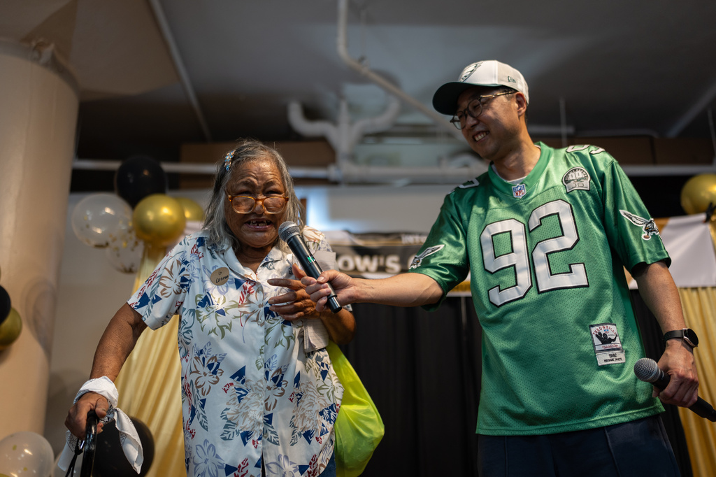 Host and volunteer Soohyung Lee, right, holds a microphone for contestant Roxanne Tomiyasu during Skid Row's inaugural talent show in downtown Los Angeles, Saturday, Sept. 19, 2026. (AP Photo/Jae C. Hong)