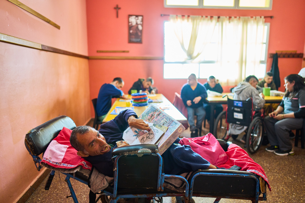 Raul colors an illustration of Spiderman in a painting workshop at the Pequeño Cottolengo Don Orione, a home for people with disabilities that will be visited by Pope Leo XIV in November, in Buenos Aires, Argentina, Thursday, Sept. 24, 2026. (AP Photo/Rodrigo Abd)