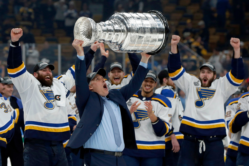 FILE - St. Louis Blues coach Craig Berube carries the Stanley Cup after the Blues defeated the Boston Bruins in Game 7 of the NHL Stanley Cup Final in Boston, June 12, 2019. (AP Photo/Michael Dwyer, File)