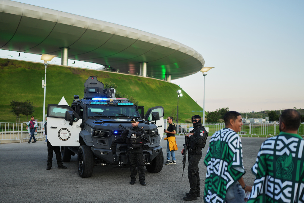 Police officers stand guard outside Akron Stadium prior to a friendly match between Mexico and Ecuador in Guadalajara, Mexico, Tuesday, Oct. 14, 2025. (AP Photo/Eduardo Verdugo)
