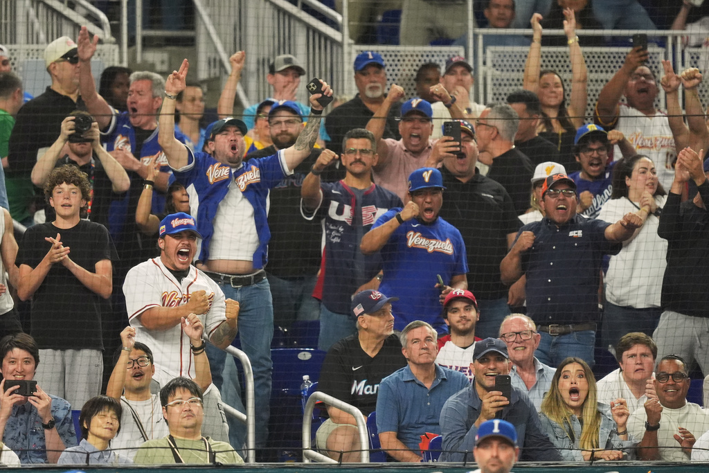 Venezuela fans cheer the team during the sixth inning of a World Baseball Classic semifinal game against Italy, Monday, March 16, 2026, in Miami. (AP Photo/Rebecca Blackwell)