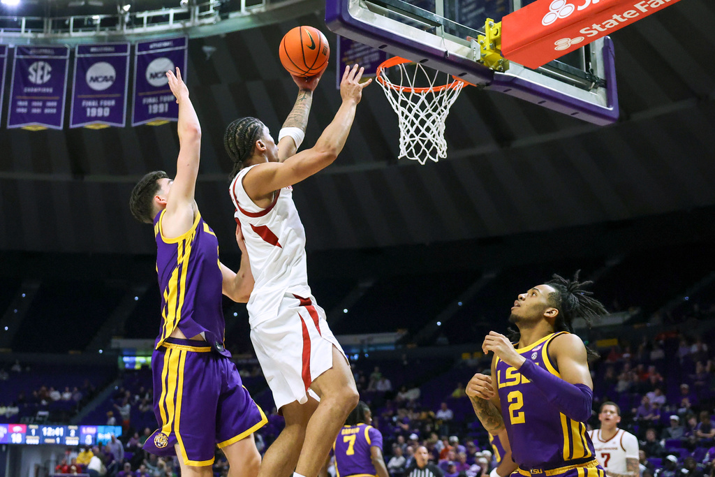 Arkansas guard Darius Acuff Jr., right, gets past LSU guard Max MacKinnon, left, for a layup during the first half of an NCAA college basketball game in Baton Rouge, La., Tuesday, Feb. 10, 2026. (AP Photo/Peter Forest)