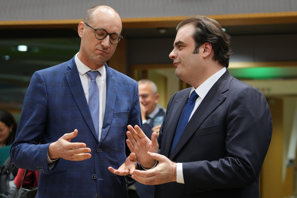 Belgium's Finance Minister Vincent Van Peteghem, left, speaks with Greece's Finance Minister Kyriakos Pierrakakis during a meeting of eurozone finance ministers at the EU Council building in Brussels, Thursday, Dec. 11, 2025. (AP Photo/Virginia Mayo)