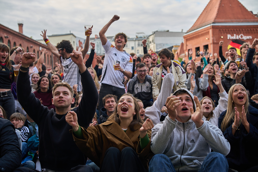 Fans watch the World Cup soccer match between Germany and Curacao, in the inner courtyard of the Kulturbrauerei in Berlin, Germany, Sunday, June 14, 2026. (AP Photo/Ebrahim Noroozi)