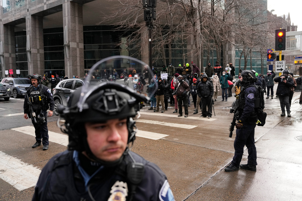 Minneapolis Police officers secure the intersection where protesters are gathered Saturday, Jan. 17, 2026, in Minneapolis. (AP Photo/Yuki Iwamura)