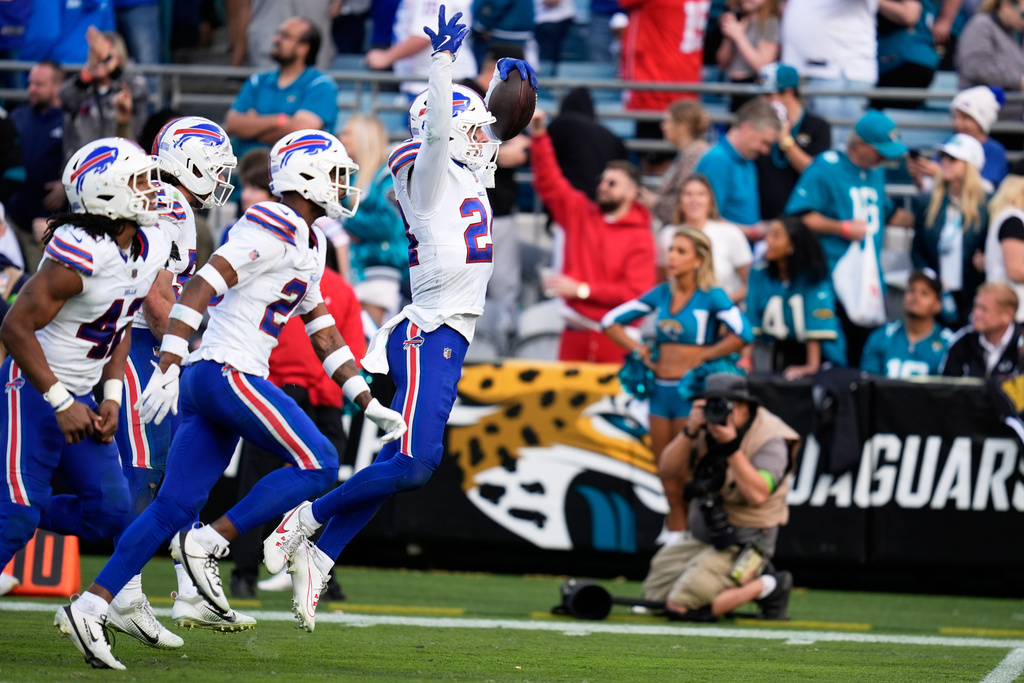Buffalo Bills safety Cole Bishop, right, celebrates with teammates after intercepting a pass by Jacksonville Jaguars quarterback Trevor Lawrence, not visible, during the second half of an NFL wild-card playoff football game Sunday, Jan. 11, 2026, in Jacksonville, Fla. (AP Photo/John Raoux)