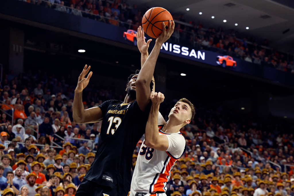Vanderbilt forward Jalen Washington (13) goes up for a shot with Auburn forward Filip Jovic (38) defending during the first half of an NCAA college basketball game Tuesday, Feb. 10, 2026, in Auburn, Ala. (AP Photo/Butch Dill)