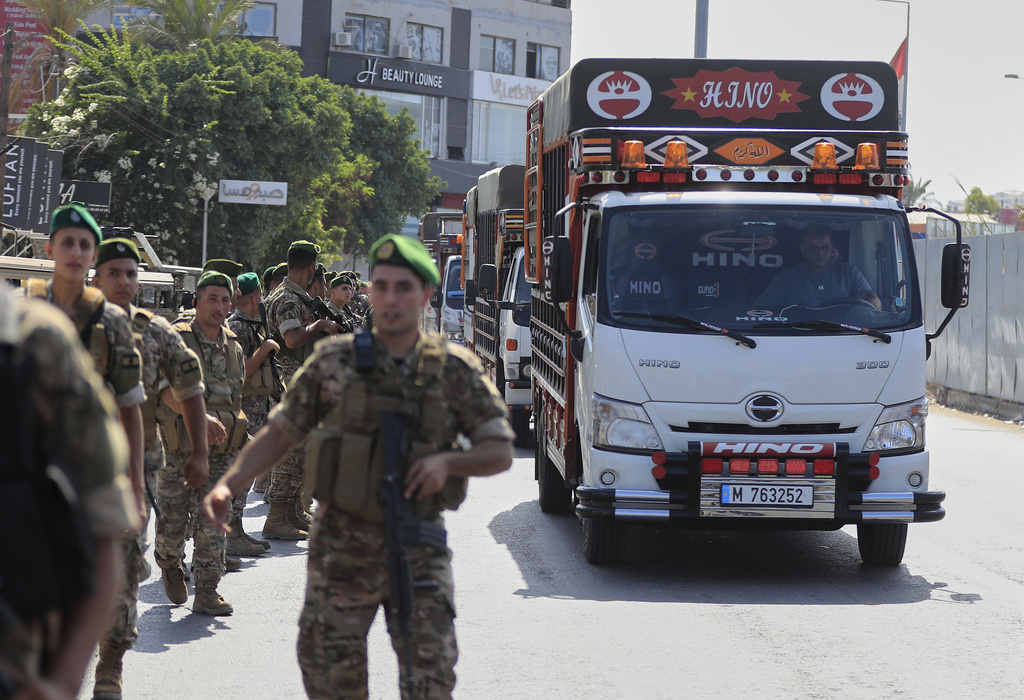 Lebanese army soldiers escort trucks carrying weapons handed over by Palestinian factions from Rashidiyeh refugee camp to the Lebanese army, as they pass in Tyre city, south Lebanon, Thursday, Aug. 28, 2025. (AP Photo/Mohammed Zaatari)