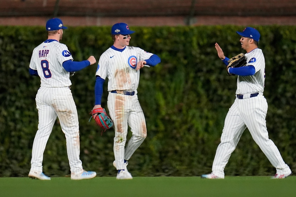Chicago Cubs' Ian Happ, Pete Crow-Armstrong and Seiya Suzuki celebrate after Game 3 of baseball's National League Division Series against the Milwaukee Brewers Wednesday, Oct. 8, 2025, in Chicago. (AP Photo/Erin Hooley)