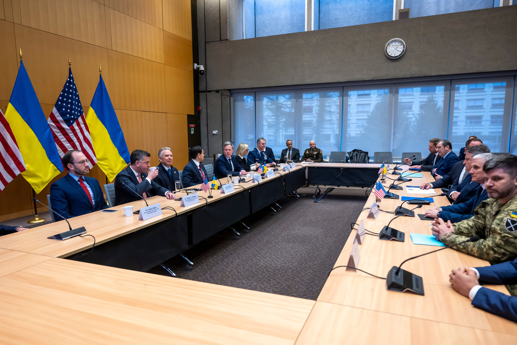 U.S., left, and Ukrainian, right, delegations at the beginning of their talks at the U.S. Mission to International Organizations in Geneva, Switzerland, Sunday, Nov. 23, 2025. (Martial Trezzini/Keystone via AP)