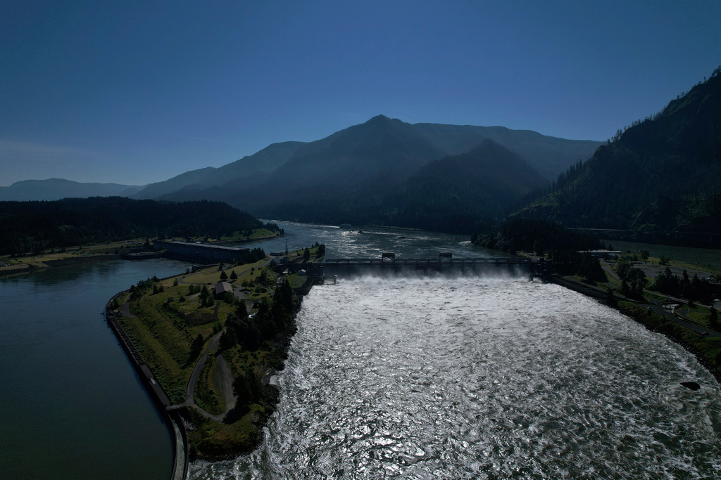 FILE - Water spills over the Bonneville Dam on the Columbia River, which runs along the Washington and Oregon state line, June 21, 2022. (AP Photo/Jessie Wardarski, File)