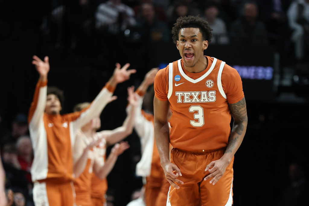 Texas forward Dailyn Swain (3) react during the first half in the second round of the NCAA college basketball tournament against Gonzaga, Saturday, March 21, 2026, in Portland, Ore. (AP Photo/Craig Mitchelldyer)