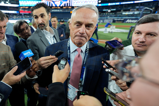 MLB commissioner Rob Manfred speaks prior to Game 2 of baseball's World Series between the Toronto Blue Jays and the Los Angeles Dodgers, Saturday, Oct. 25, 2025, in Toronto. (AP Photo/David J. Phillip) MLB commissioner Rob Manfred speaks prior to Game 2 of baseball's World Series between the Toronto Blue Jays and the Los Angeles Dodgers, Saturday, Oct. 25, 2025, in Toronto. (AP Photo/David J. Phillip)