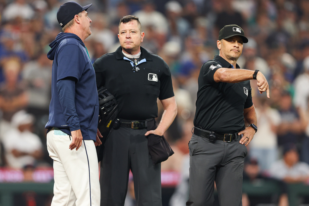 First base umpire Mark Wegner ejects Seattle Mariners manager Dan Wilson in the eighth inning of a baseball game against the Detroit Tigers, Wednesday, Aug. 5, 2026, in Seattle. (AP Photo/Kevin Ng)