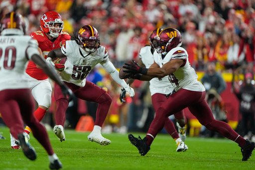 Washington Commanders linebacker Bobby Wagner, right, intercepts a pass intended for Kansas City Chiefs tight end Travis Kelce (87) as Commanders' Jordan Magee (58) watches during the first half of an NFL football game Monday, Oct. 27, 2025, in Kansas City, Mo. (AP Photo/Charlie Riedel) Washington Commanders linebacker Bobby Wagner, right, intercepts a pass intended for Kansas City Chiefs tight end Travis Kelce (87) as Commanders' Jordan Magee (58) watches during the first half of an NFL football game Monday, Oct. 27, 2025, in Kansas City, Mo. (AP Photo/Charlie Riedel)