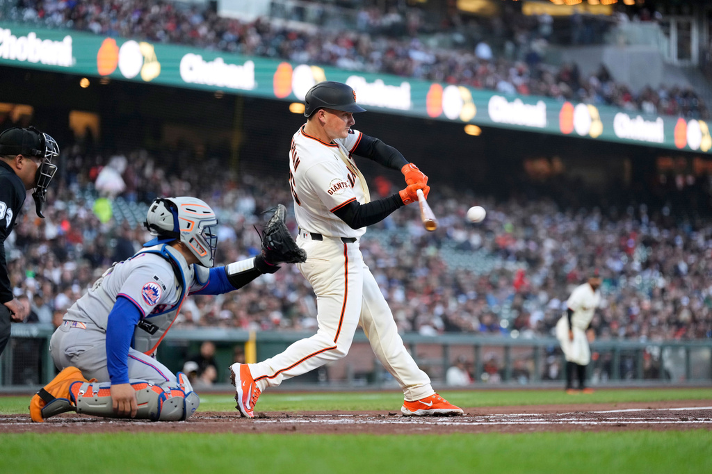San Francisco Giants' Matt Chapman hits an RBI double against the New York Mets during the first inning of a baseball game in San Francisco, Thursday, April 2, 2026. (AP Photo/Tony Avelar)