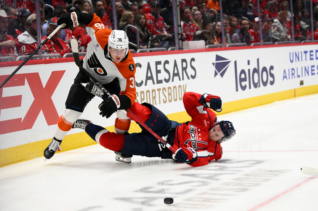 Philadelphia Flyers defenseman Emil Andrae (36) collides with Washington Capitals left wing Ivan Miroshnichenko (63) during the first period of an NHL hockey game, Tuesday, March 31, 2026, in Washington. (AP Photo/Nick Wass)