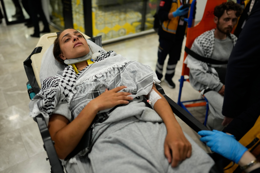An activist from the Global Sumud Flotilla is carried on a wheel stretcher upon her arrival at Istanbul Airport, in Istanbul, Turkey, Thursday, May 21, 2026. (AP Photo/Emrah Gurel)