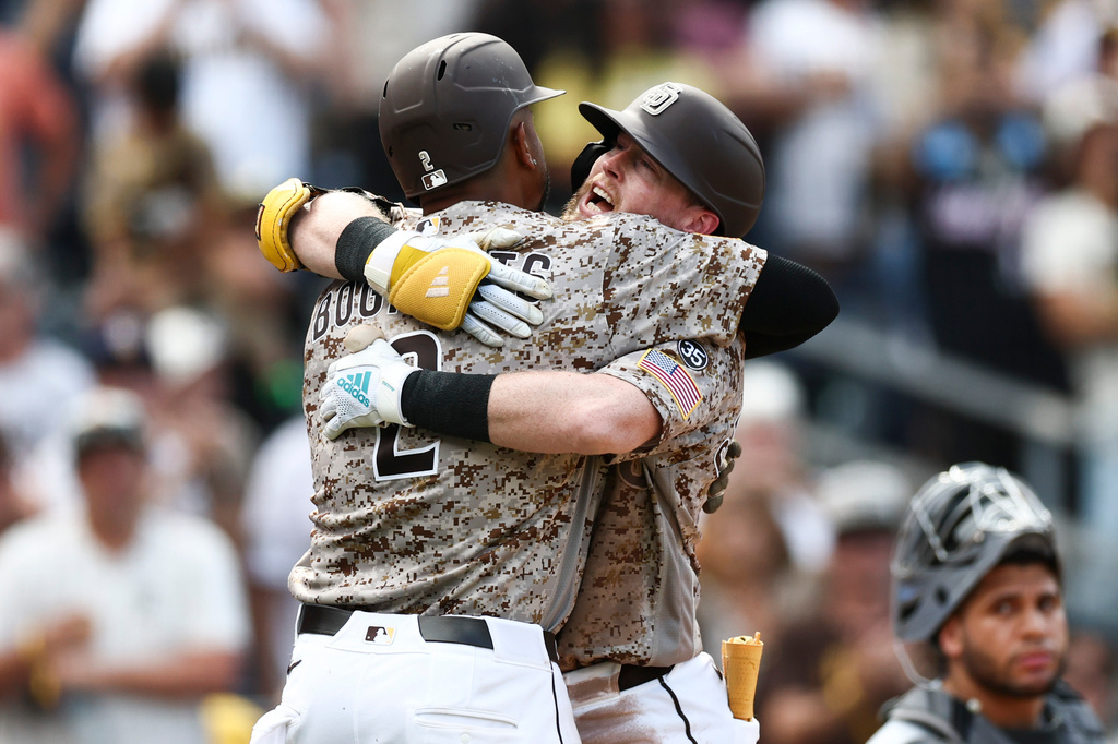 San Diego Padres' Jake Cronenworth, second from left, celebrates after his two-run home run with Xander Bogaerts, left, in the eighth inning of a baseball game against the Miami Marlins, Sunday, Sept. 20, 2026, in San Diego. (AP Photo/Karl Anderson)