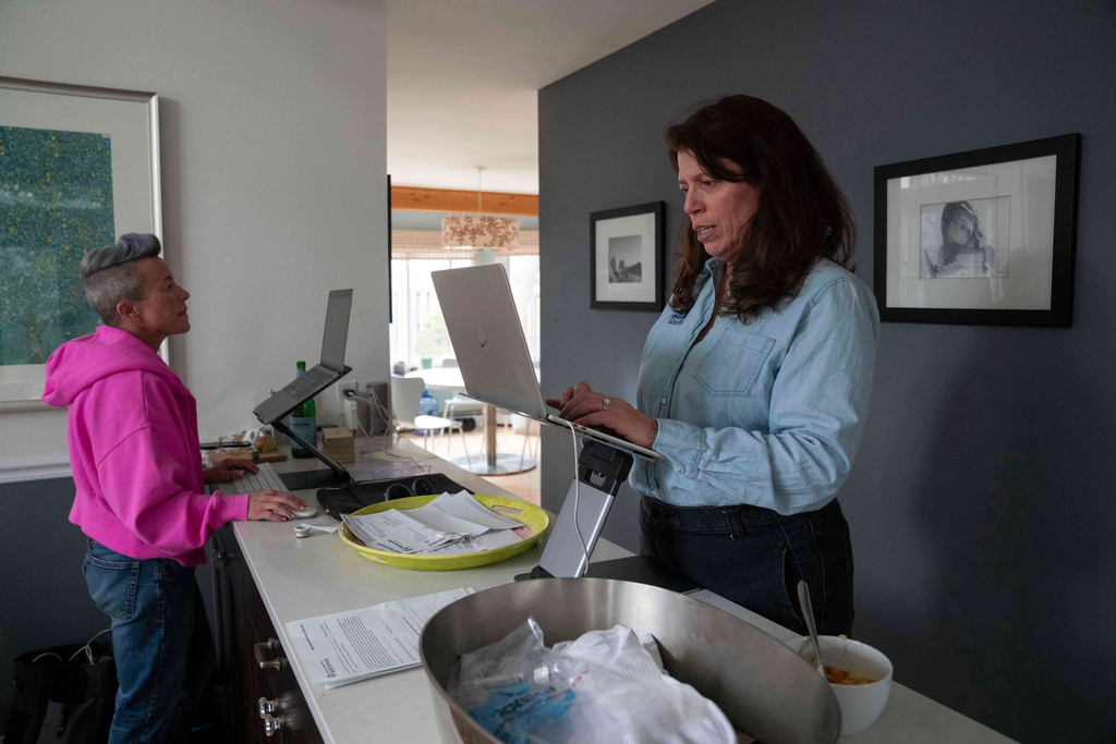 CEO of the Chef Ann Foundation, Mara Fleishman, a winner of this year's Elevate Prize, works alongside her executive assistant Kim Rosenbarger at her home, Monday, Feb. 16, 2026, in Boulder, Colo. (AP Photo/Rebecca Slezak)