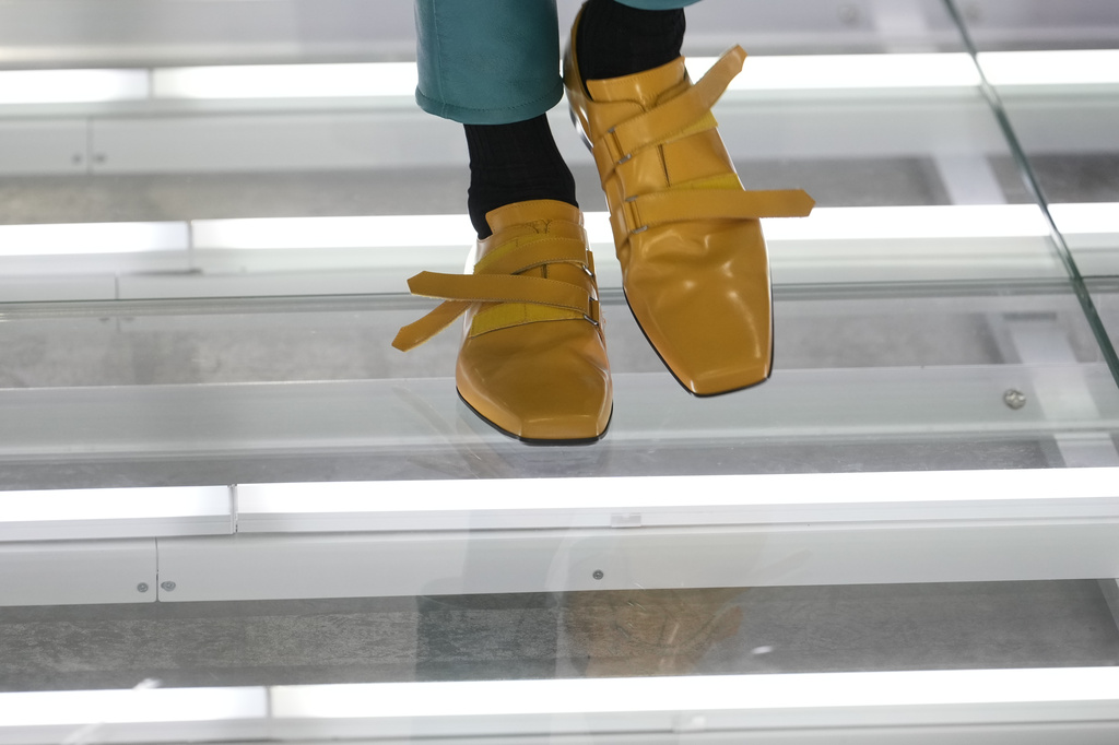 A model wears a creation from Prada's Spring/Summer 2027 men's collection presented in Milan, Italy, Sunday, June 21, 2026. (AP Photo/Luca Bruno)