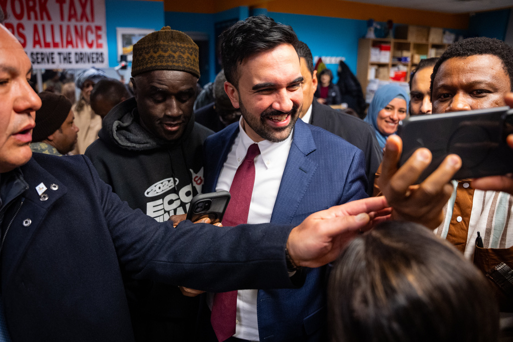 People greet and take photos with New York City Mayor Zohran Mamdani at a Ramadan Iftar hosted by his team at the New York Taxi Workers Association, Wednesday, March 18, 2026, in New York. (AP Photo/Angelina Katsanis)