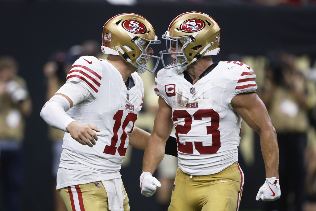 San Francisco 49ers quarterback Mac Jones (10) celebrates with running back Christian McCaffrey (23) during the second half of an NFL football game against the New Orleans Saints in New Orleans, Sunday, Sept. 14, 2025. (AP Photo/Butch Dill)