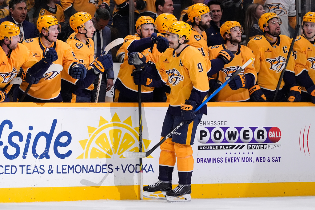 Nashville Predators left wing Filip Forsberg (9) celebrates his shootout goal with teammates during overtime of an NHL hockey game against the New York Islanders, Thursday, Jan. 8, 2026, in Nashville, Tenn. (AP Photo/George Walker IV)