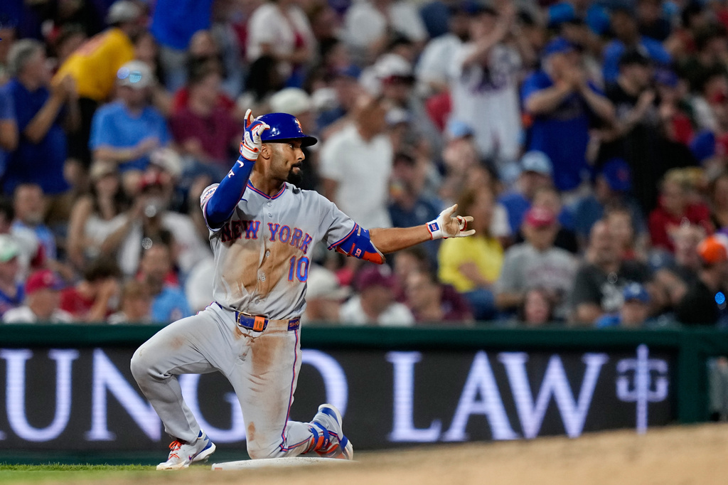 New York Mets' Marcus Semien reacts after hitting a two-run triple against Philadelphia Phillies pitcher José Alvarado during the seventh inning of a baseball game Thursday, June 18, 2026, in Philadelphia. (AP Photo/Matt Slocum)