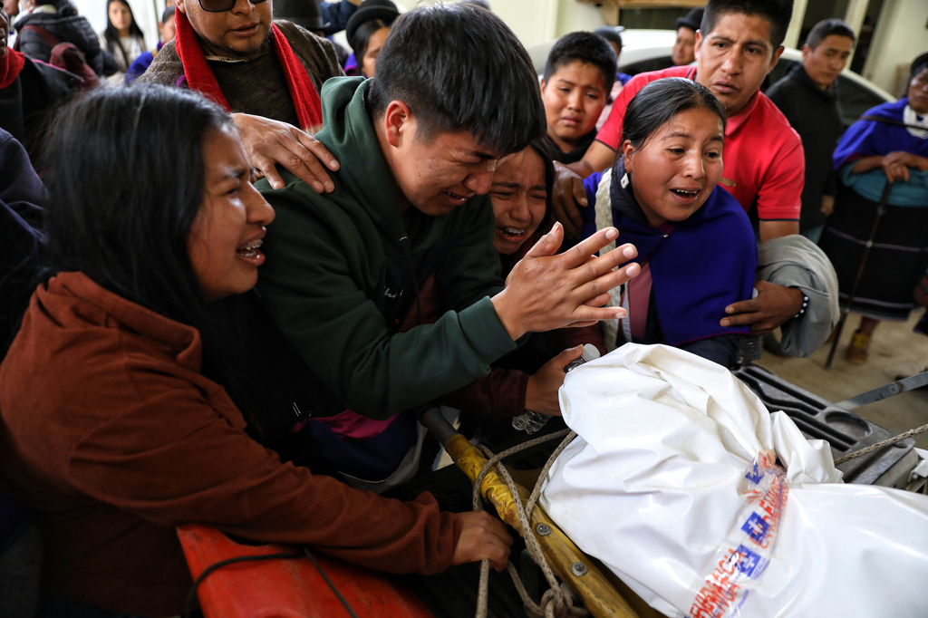 Members of the Misak community mourn as forensic investigators deliver the body of Luis Tunubala, governor of the Guambia Indigenous reserve, who was killed during clashes with the Nasa community over a land dispute in Silvia, Colombia, Friday, May 22, 2026. (AP Photo/Santiago Saldarriaga)