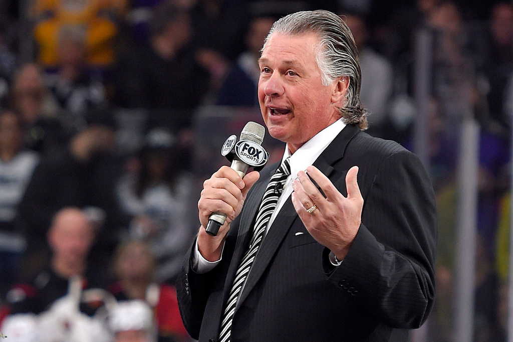 FILE - Former Los Angeles Kings coach Barry Melrose speaks to fans as he is honored prior to an NHL hockey game between the Kings and the Calgary Flames, on Feb. 12, 2015, in Los Angeles. (AP Photo/Mark J. Terrill, File)