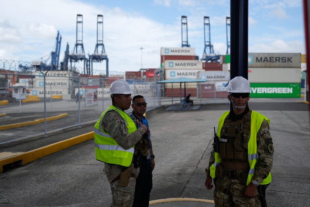 Workers stand at the entrance of the Balboa terminal, run by CK Hutchison's Panama Ports Co., after Panama government ordered the occupation of the port following a Supreme Court ruling that the concession was unconstitutional inPanama City, Panama, Monday, Feb. 23, 2026. (AP Photo/Matias Delacroix)
