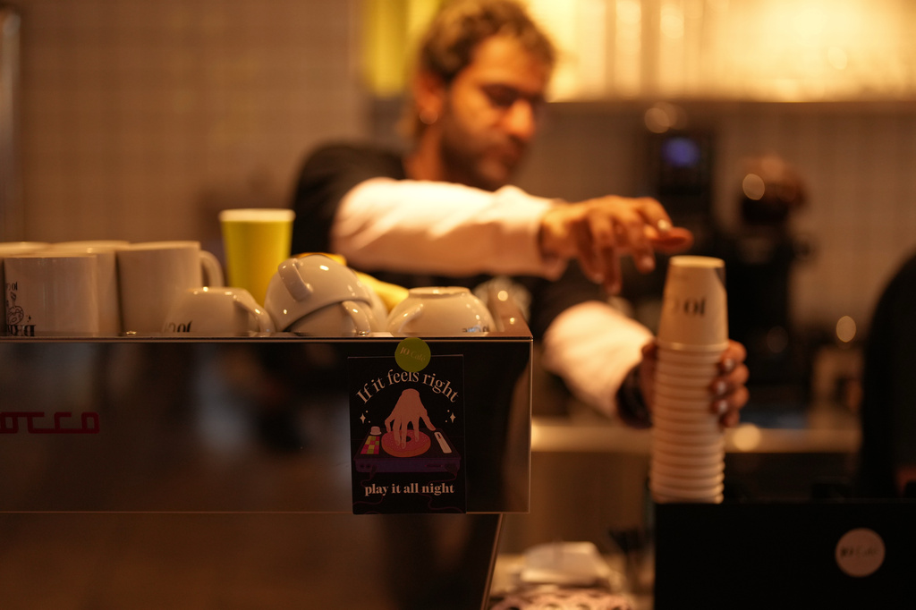 A worker prepares coffee in a café in central Tehran, Iran, Wednesday, April 8, 2026. (AP Photo/Francisco Seco)