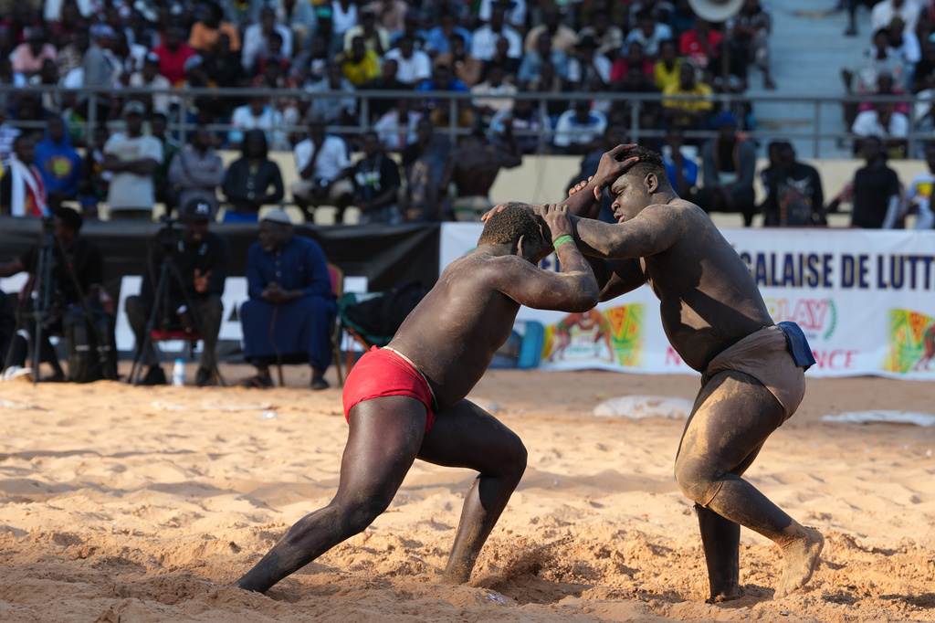 Wrestlers compete at the national wrestling arena in Dakar, Senegal, Sunday, April 5, 2026. (AP Photo/Misper Apawu)